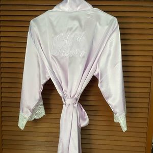 Lavender/lilac colored silky Maid of Honor robe with white lace trim.